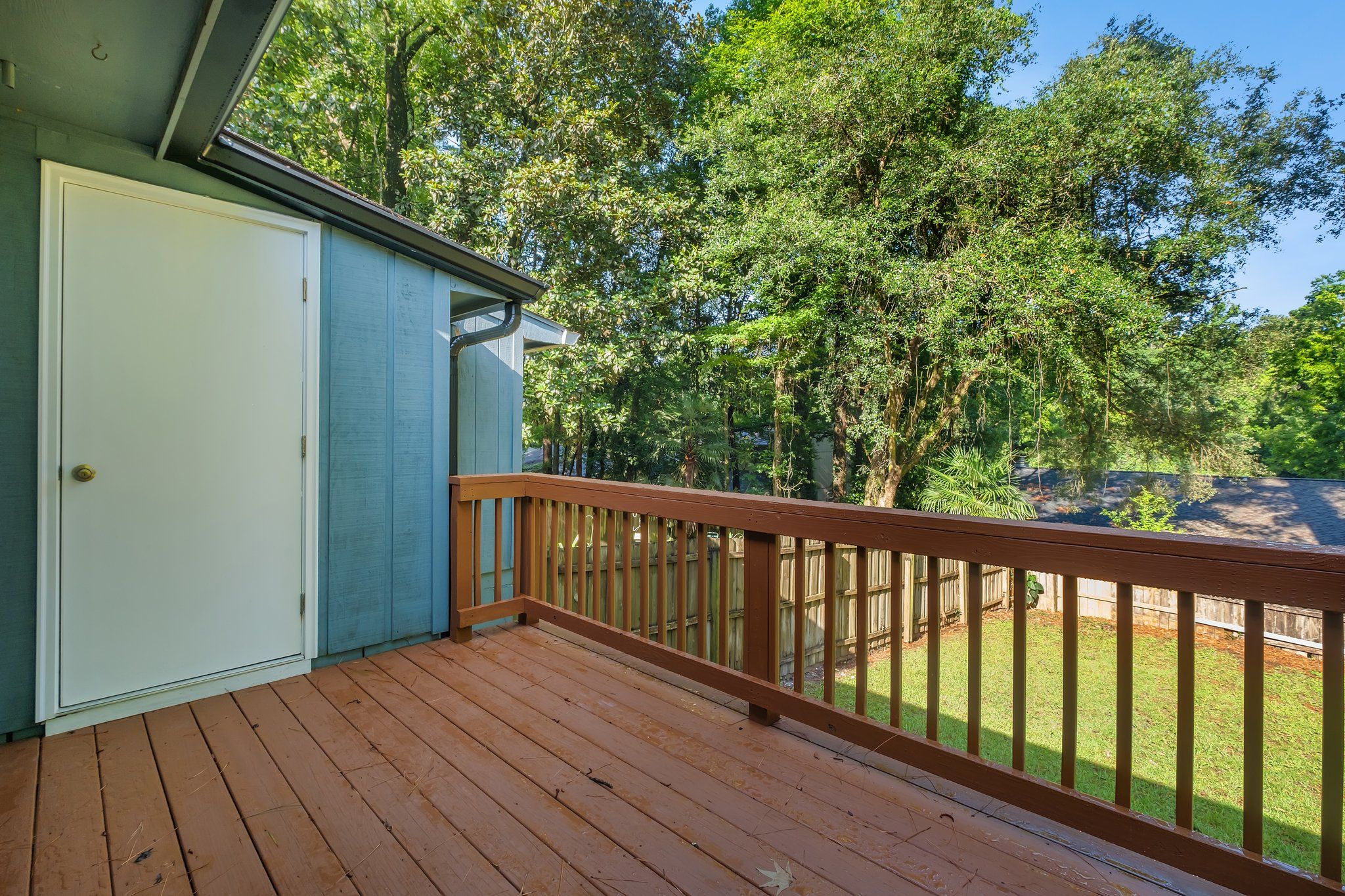 Wood deck off the back of the townhome, looking out to the trees